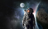 Fototapeta Kosmos - Astronaut explorer in space. Mixed media