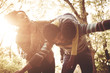 © Mladen - Smiling African American parents playing with daughter in nature.