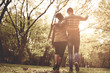 © Mladen - Young African American couple in park walking and having conversation. From back.