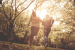 © Mladen - Young African American couple running and catching in park. From back.