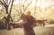 © Mladen - Happy African America woman with open arms dancing on meadow.