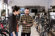 © ReeldealHD images - Small business owner serving customer in a bike store