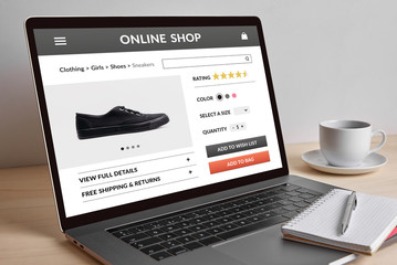 Online shop concept on modern laptop computer screen on wooden table. All screen content is designed by me. 