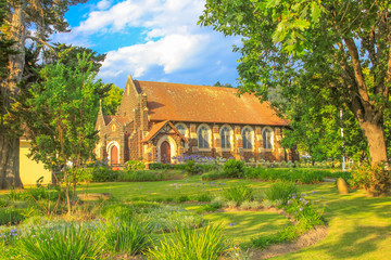 Wall Mural - Side view of historic St. Georges Anglican Church in Knysna on the Garden Route in Western Cape, South Africa. The old Church as built in 1855. Sunny day, blue sky.