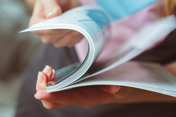 woman reading magazine at home