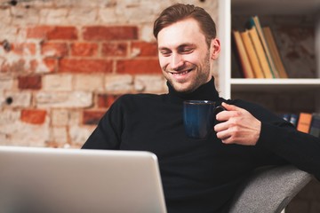 Wall Mural - Young man with a laptop