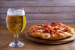Beer and pizza. Glass of beer. Ale and appetizer snack.