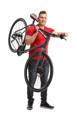 Young man holding a bicycle on his shoulder