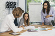 © loreanto - Young pregnant woman at work with his associates in the office during a meeting