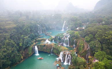 Wall Mural - Aerial view on the Ban Gioc Waterfall at cloudy March  - the most magnificent waterfall in Vietnam