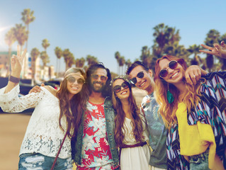 Sticker - summer holidays, vacation, travel and people concept - smiling young hippie friends showing peace hand sign over venice beach in los angeles background