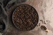 coffee bean in  bowl on cooper texture,top view