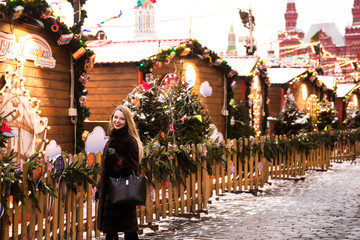 Wall Mural - Portrait in full growth, Russian beautiful woman in a mink coat on the Red Square in Moscow in Christmas time