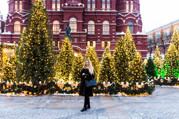 Wall Mural - Portrait in full growth, Russian beautiful woman in a mink coat on the Red Square in Moscow in Christmas time