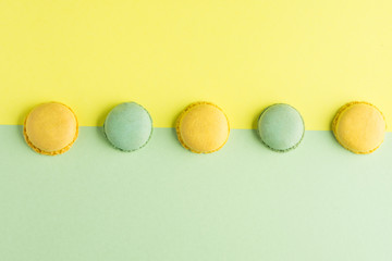 colorful macaroons on green and yellow background