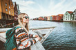 Leinwanddruck Bild - Young blonde woman traveling in Trondheim city Norway vacations weekend Lifestyle outdoor girl tourist with backpack sightseeing scandinavian architecture alone