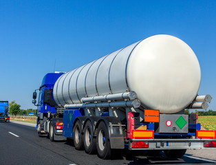 Wall Mural - Large automotive fuel tanker truck driving on highway. Fuel transportation