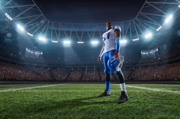 Wall Mural - American football player performs an action play on professional sport stadium