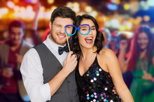 Celebration, Fun And Holidays Concept - Happy Couple Posing With Party Glasses Over Night Club Lights Background