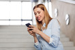 © Syda Productions - technology, business and corporate concept - happy smiling woman or student with smartphone at office stairs