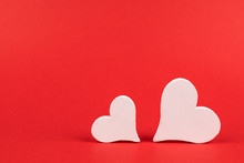 Two White Hearts On Red Background