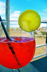 Wall Mural - Colorful cocktail drink on wood table in beach bar, soft focus