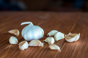 Close-up view of raw healthy organic garlic cloves on rustic wooden table, selective Focus