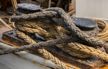 Wall Mural - Close-up nautical knot rope tied around stake on ship