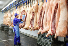 Butcher Cutting Pork  At The Meat Manufacturing.