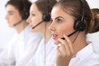 © rogerphoto - Call center. Focus on beautiful woman in headset