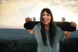 Fototapeta  - Woman with skateboard outdoors