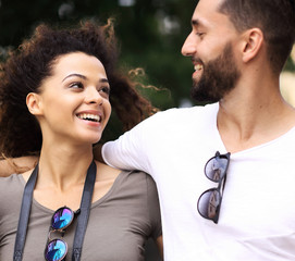 Poster - Cheerful young couple walking on urban street