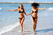 © javiindy - Two young women with beautiful bodies in swimwear on a tropical beach