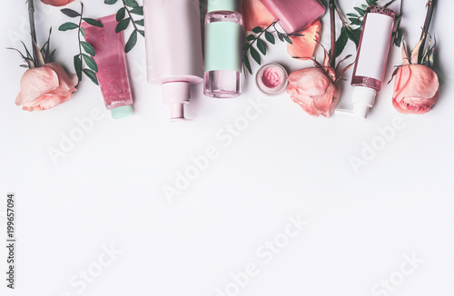 Fotografía Cosmetics set with Rose essential oils: toner,serum, essence,moisturizer and and others on white desktop background, top view, border