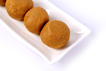 Besan Laddoo - Roasted gram flour mixed with Desi Ghee and sugar to make tasty and round shape sweet Laddu. selective focus