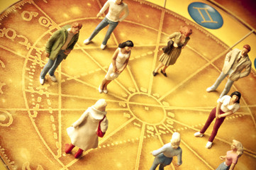 people figures standing on horoscope with zodiac signs like a concept astrology and people