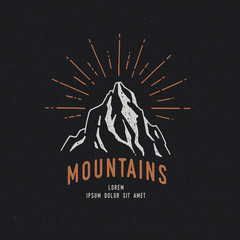 Wall Mural - Hand Drawn mountains. Sketch illustration. Adventure logo isolated on dark background. Vintage trendy label.