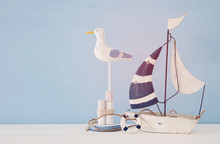 Nautical Concept With White Decorative Seagull Bird And Boat Over Light Blue Background.
