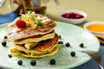 Canvas Print - Sweet delicious pancake blinis with jam and berries in the plate with copyspace. New restaurant menu for the holiday Maslenitsa