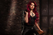 redhead adult girl biker in the leather wear indoor