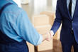 © pressmaster - Handshake of businessman in suit and worker in uniform after help with relocation to new office
