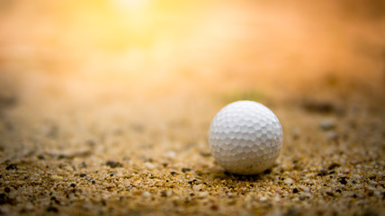 Soft golf ball on sand bunker in golf course