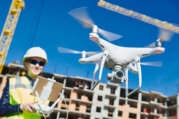 Drone operated by construction female worker on building site