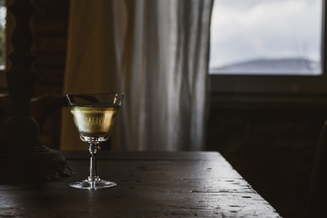 Single wine glass of wine on a rustic table