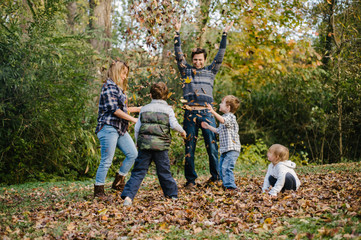 Family planning in autumn leaf pile