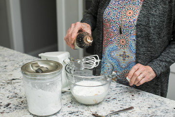 Little Girl Making Dessert with Grandmother in Modern Kitchen