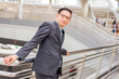 © PRASERT - Asia young business man in front of the modern building in downtown .Concept of young  business people