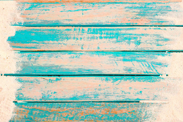 Beach background - top view of beach sand on old wood plank in blue sea paint background. summer vacation concept. vintage color tone.