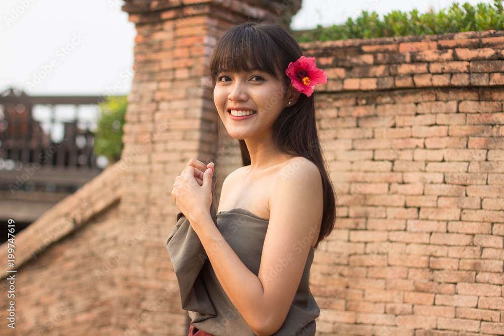 Young Thai girl put ancient Thai dress smiling, central region of