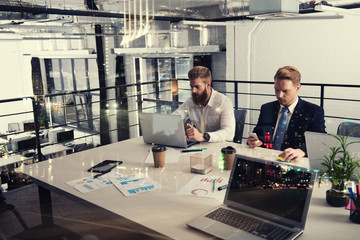 Business people that work together in office at the night. Concept of teamwork and partnership. double exposure